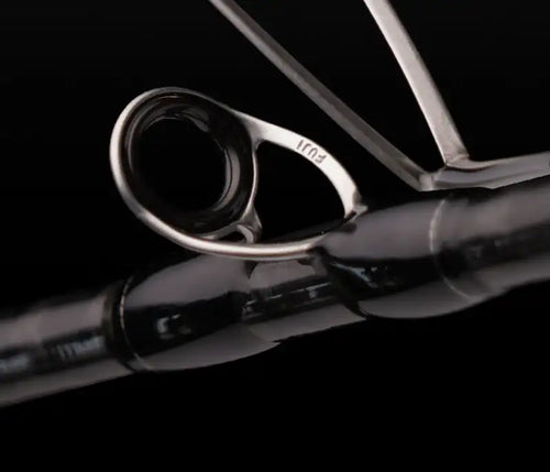 Fishing rod guide ring close-up showing O-ring frame and rod blank joint