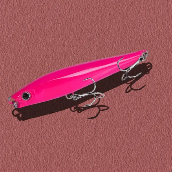 Neon pink lipless minnow fishing lure with black back and silver treble hooks