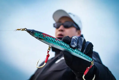 Floating pencil sea fishing lure, turquoise scale pattern with red hook accents