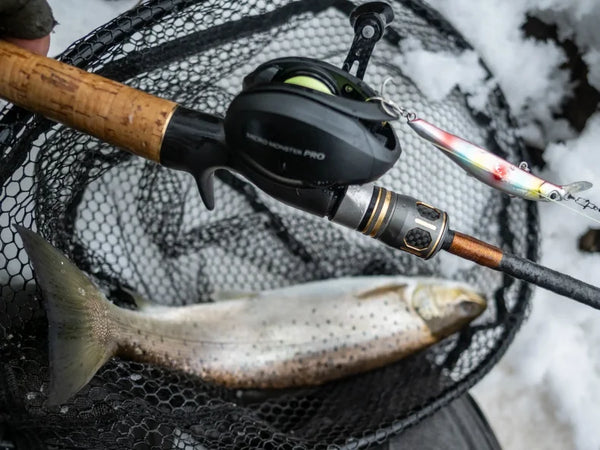 Black micro baitcasting reel mounted on a fishing rod over a net