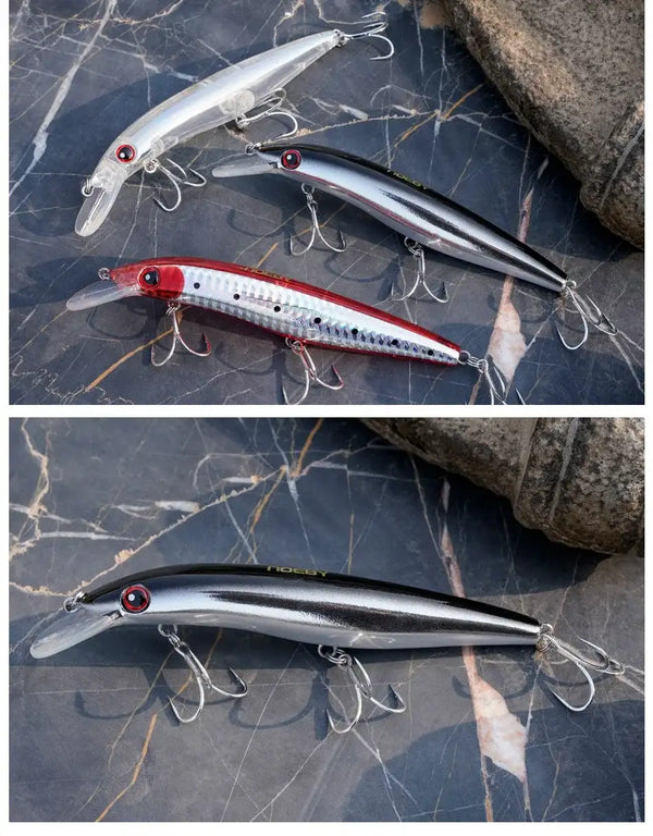 Two shallow trolling minnow lures on blue stone, silver and white/red bodies