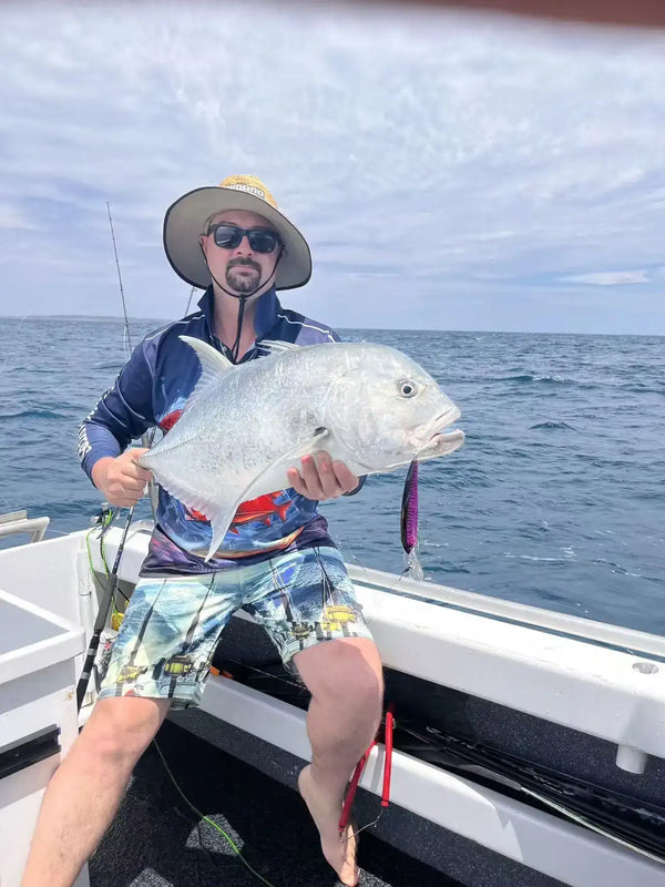 Angler holding a large fish caught while trolling with a minnow-style lure