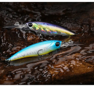 Suspending minnow fishing lure, blue-green and silver with black eye and treble hooks.