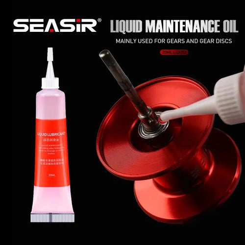 SEASIR liquid maintenance oil tube, pink lubricant bottle being applied to a fishing reel