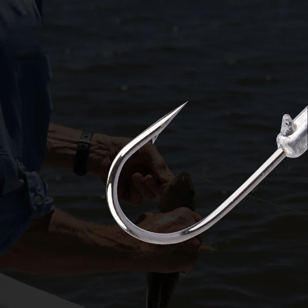 Large jig head fishing hook, silver metal, long shank with sharp barbed point
