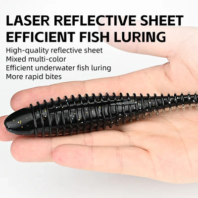 Black ribbed silicone T-tail fishing lure with reflective sheet detail, held in hand