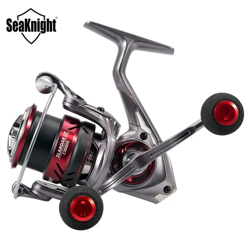 Angled view of silver spinning fishing reel with black grips and red end caps