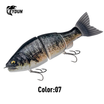 Dark gray and silver jointed swimbait lure with yellow-green eye and treble hooks