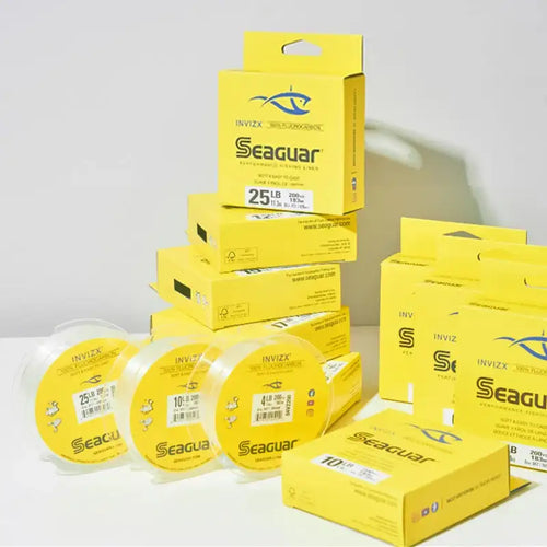 Fluorocarbon fishing line spools with stacked yellow Seaguar boxes