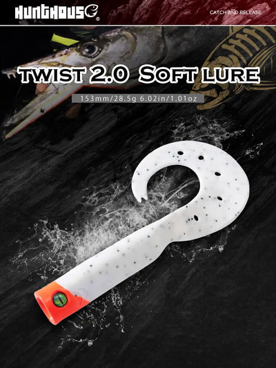 White soft fishing lure with black speckles and orange head, curved single tail.