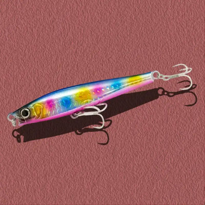 Metallic lipless minnow lure with pink-blue-yellow body and three treble hooks