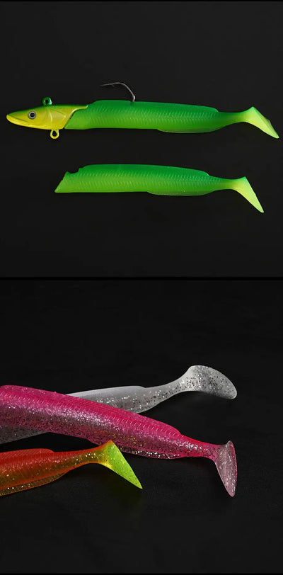 Soft paddle tail lures with treble hooks: green and dark silver, plus pink/red accents.