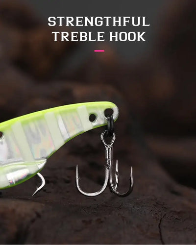 A bright lime-green and silver metallic tsurinoya ares-a metal vib lure with treble hook and low centre of gravity