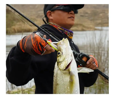 Orange half-finger fishing gloves gripping a fish near the handle