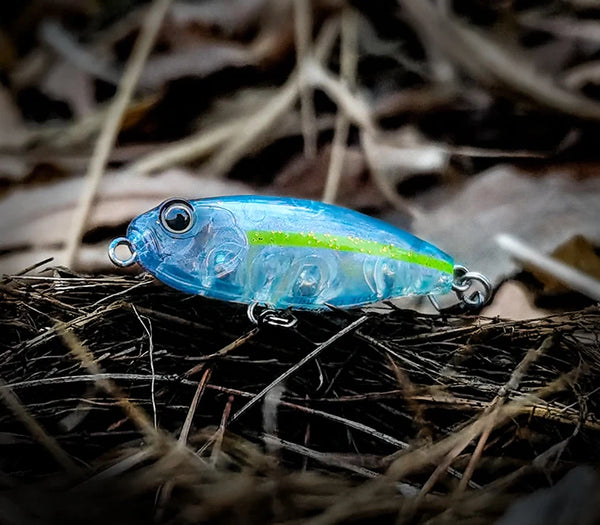 Floating pencil topwater lure, translucent blue with chartreuse stripe and two treble hooks