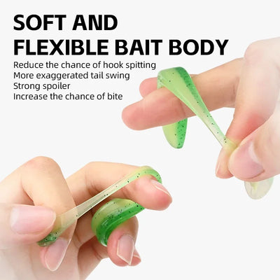 Green silicone T-tail swimbait held between fingers