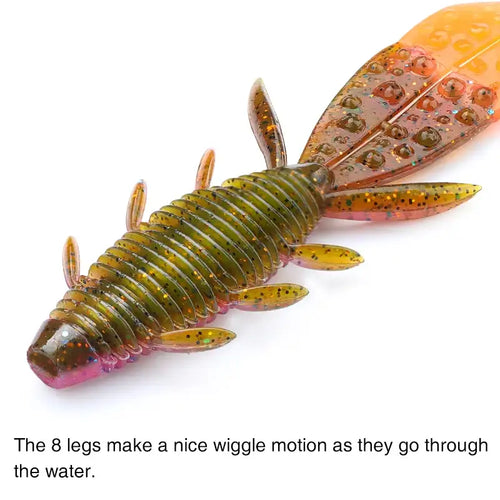 Orange-yellow Nebula shrimp soft lure with translucent body, glitter dots, and visible legs.