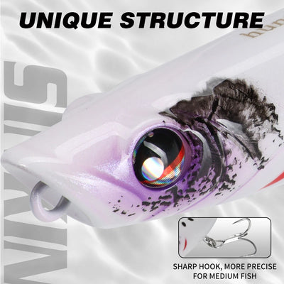Topwater popper lure close-up, white body with purple-speckled face and rainbow eye