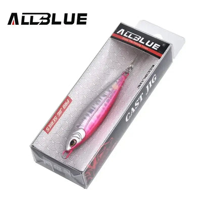 Fishing lure jig in retail box, pink and silver metal body with treble hooks