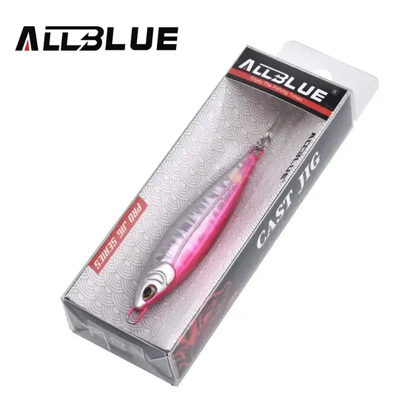 Fishing lure jig in retail box, pink and silver metal body with treble hooks
