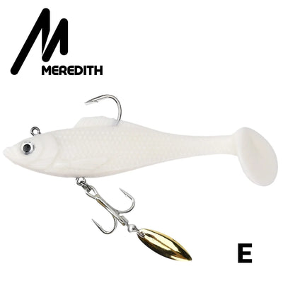 White soft plastic swimbait lure with gold spinner blade and treble hooks