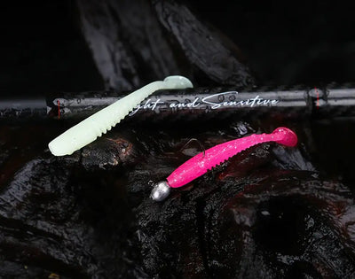 Soft plastic worm lures in white and bright pink with glitter speckle texture