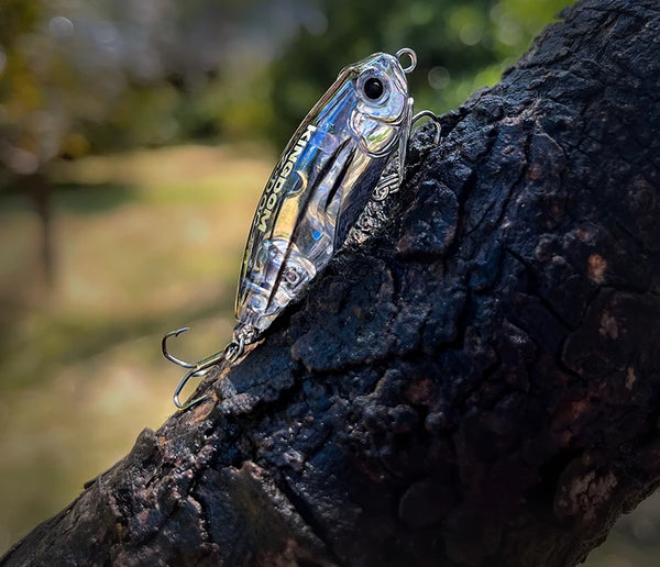 Topwater stickbait fishing lure, metallic blue with treble hooks