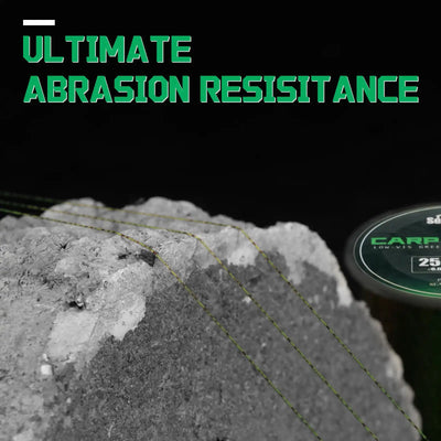 Green speckled monofilament fishing line on gravel, abrasion-resistant detail