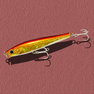 Lipless minnow fishing lure, yellow-gold body with orange back and three treble hooks