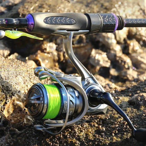 Silver spinning reel on fishing rod with bright green line spool outdoors