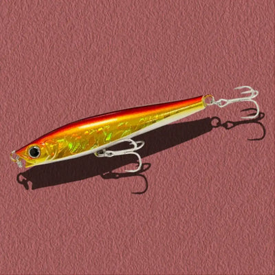 Gold metallic lipless minnow sinking lure with treble hooks and black eye