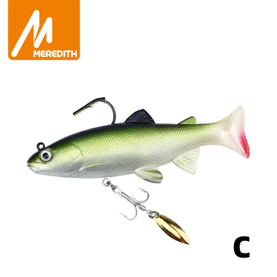 Soft swimbait lure with green back and silver sides, gold spinner blade and treble hook