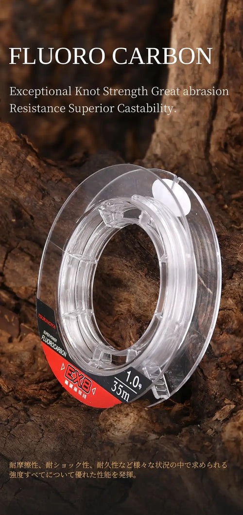 Clear EX8 fluorocarbon fishing line spool with 1.0 label on rocks