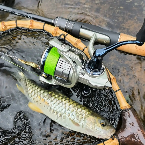 Fishing reel with neon green braided PE line spooled and fishing rod on top