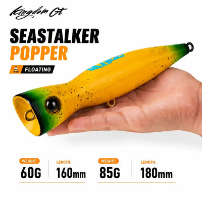 Floating popper fishing lure, yellow body with green tail, black eye, front hook ring