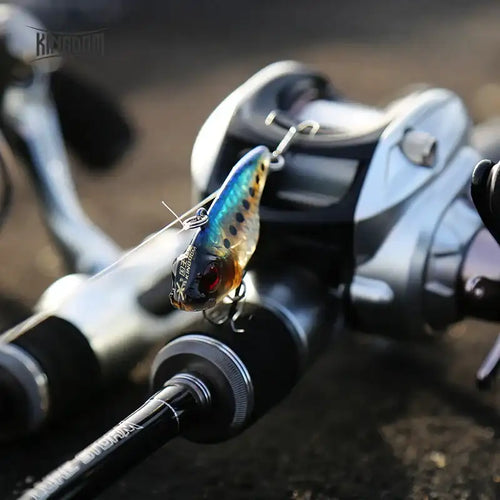 Blue-and-gold Kingdom VIB sinking hard bait lure with red eye and treble hook on line