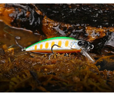Sinking minnow fishing lure with white body, orange pattern spots, and treble hooks