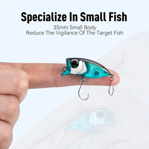 Handheld floating popper lure, teal and white body with two exposed treble hooks
