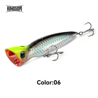 Silver and black topwater popper fishing lure with neon green tail, twin treble hooks