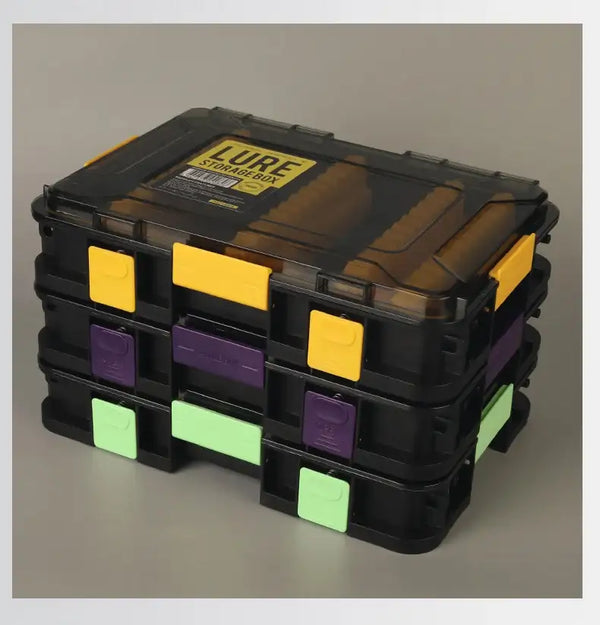 Stacked lure storage boxes with clear lids, yellow-purple-green front tabs and grid compartments