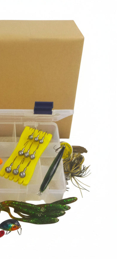 Fishing lure kit with clear box featuring a yellow jig and green soft plastic lures