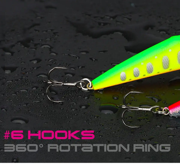 Neon green and yellow dot fishing lure with silver treble hooks on a dark surface