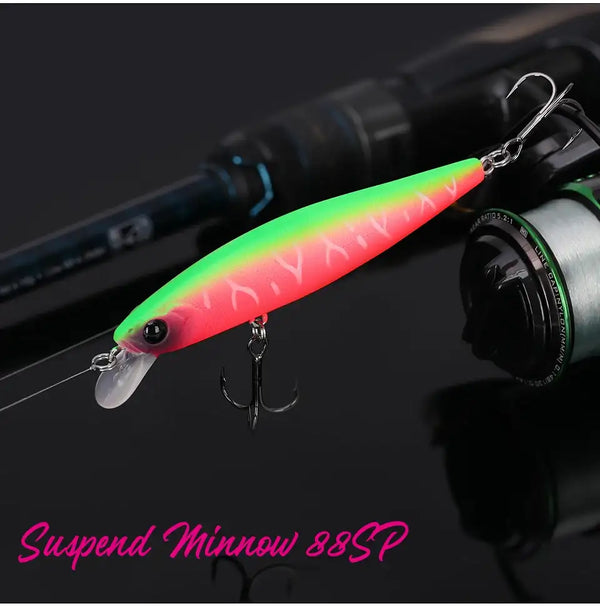 Suspending minnow jerkbait lure with neon green and pink body, black eye, and treble hooks