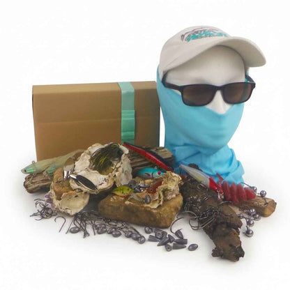 Fishing tackle gift box with blue head covering and mixed lures and hooks
